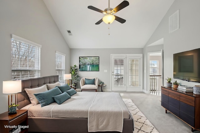 carpeted bedroom with access to outside, multiple windows, ceiling fan, and high vaulted ceiling