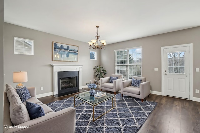 living room with dark hardwood / wood-style floors and a chandelier