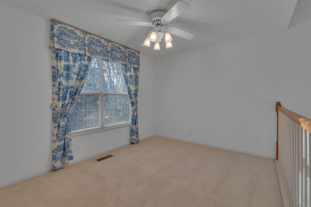 carpeted empty room featuring ceiling fan