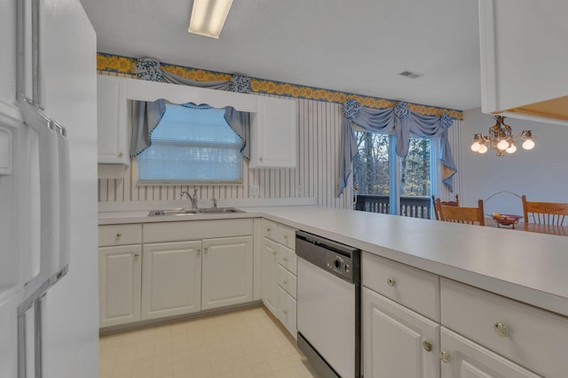 kitchen with stainless steel dishwasher, a notable chandelier, white cabinetry, and sink