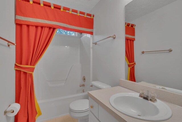 full bathroom featuring shower / bath combo, tile patterned floors, a textured ceiling, toilet, and vanity