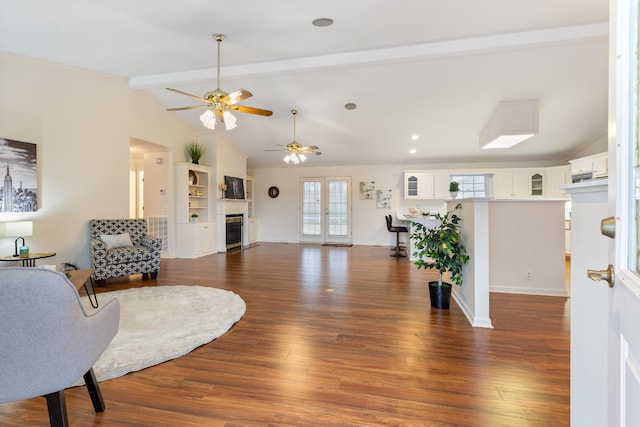 living room with vaulted ceiling with beams, ceiling fan, and dark wood-type flooring