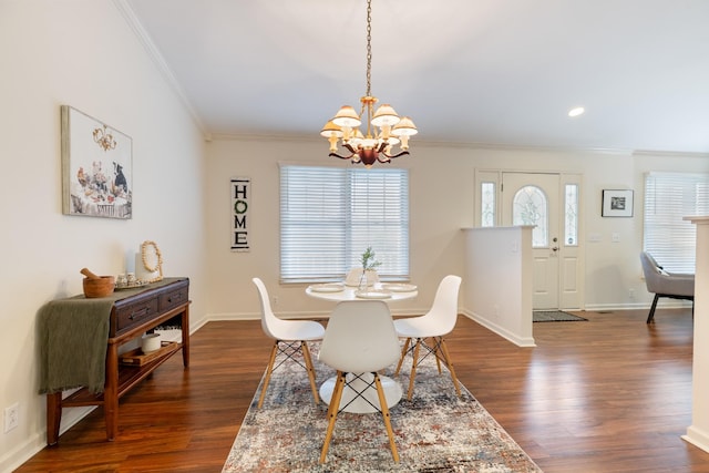 dining space featuring ornamental molding, dark wood-type flooring, and a notable chandelier