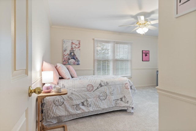 bedroom with carpet floors, ceiling fan, and crown molding