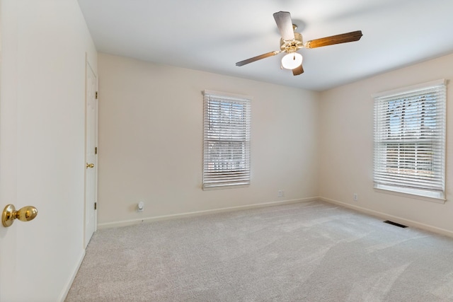 unfurnished room featuring light carpet and ceiling fan