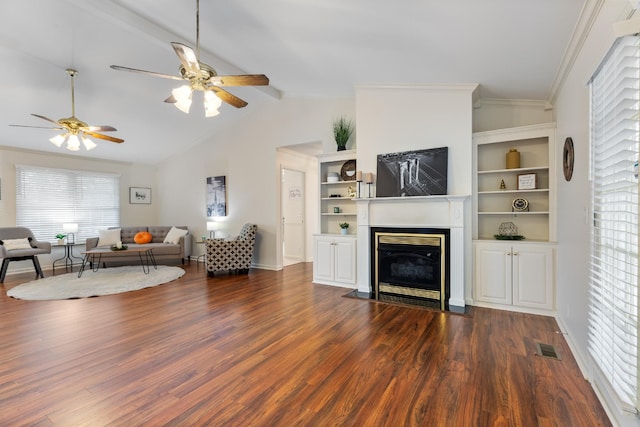 living room featuring lofted ceiling with beams, dark hardwood / wood-style floors, crown molding, and ceiling fan