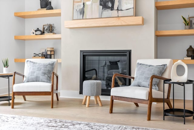 living area with hardwood / wood-style flooring