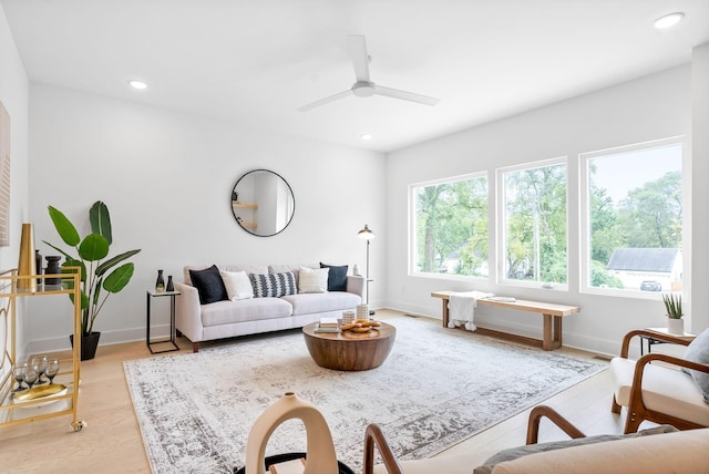 living room with ceiling fan and light hardwood / wood-style floors