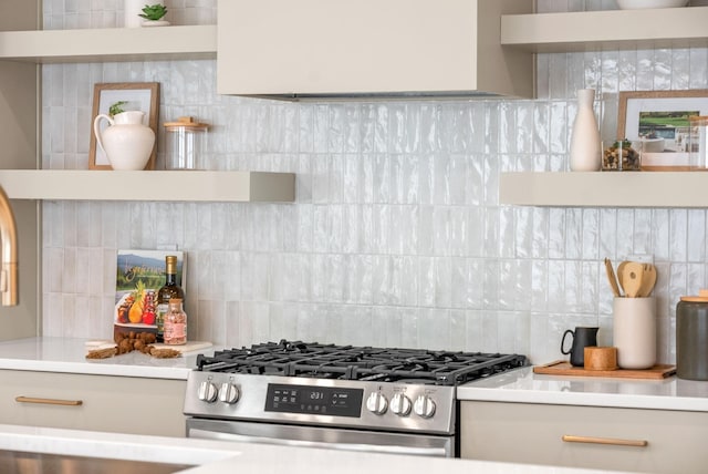 kitchen featuring tasteful backsplash and stainless steel gas range oven