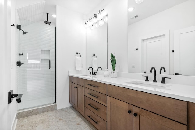 bathroom with vanity and a shower with door