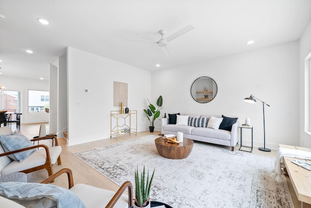 living room with ceiling fan and light hardwood / wood-style flooring