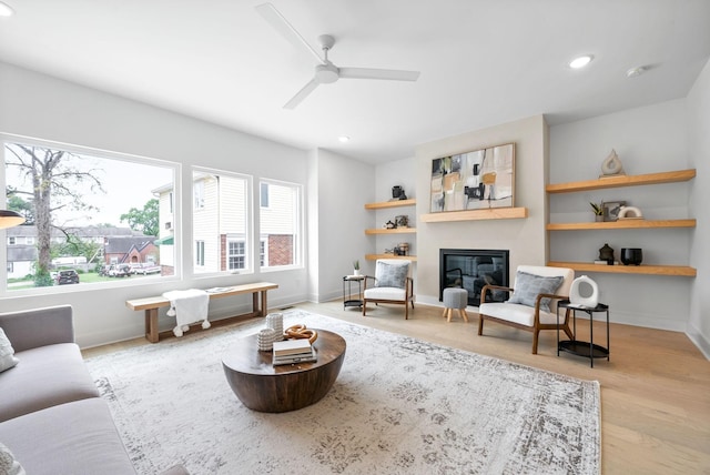 living room featuring ceiling fan and light hardwood / wood-style flooring