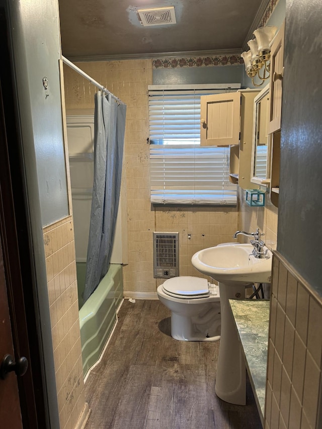 full bathroom featuring hardwood / wood-style flooring, tile walls, and heating unit