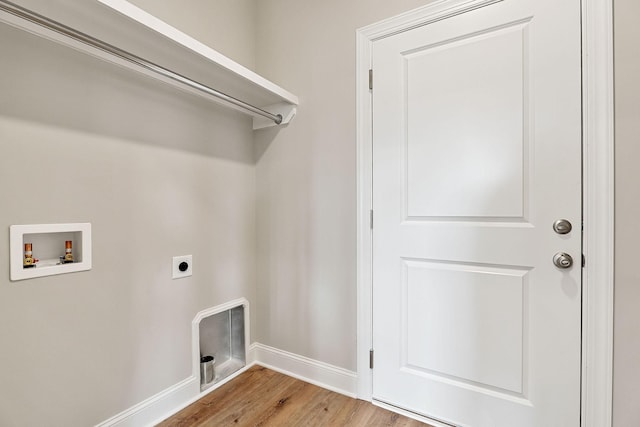 clothes washing area with hardwood / wood-style floors, electric dryer hookup, and washer hookup