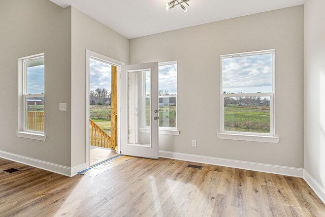 entryway with french doors and light hardwood / wood-style flooring