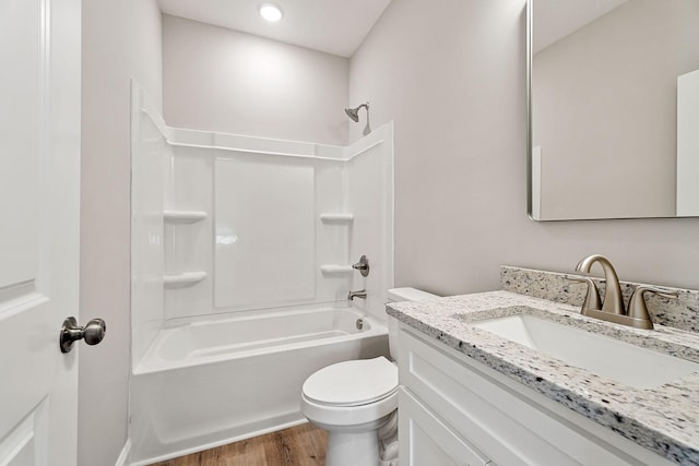 full bathroom with hardwood / wood-style floors, vanity, toilet, and shower / tub combination