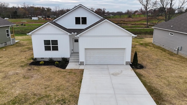 modern farmhouse featuring a front yard and a garage