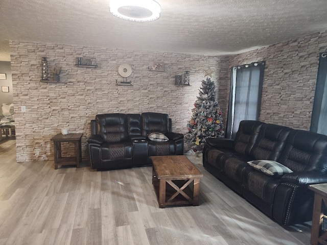 living room featuring a textured ceiling and hardwood / wood-style flooring