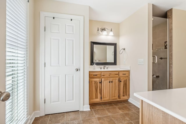 bathroom featuring tile patterned floors, vanity, and a shower with shower door