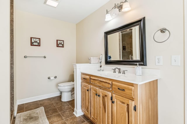 bathroom featuring tile patterned floors, vanity, and toilet