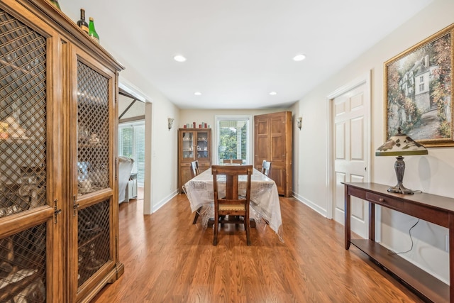 dining space with hardwood / wood-style flooring