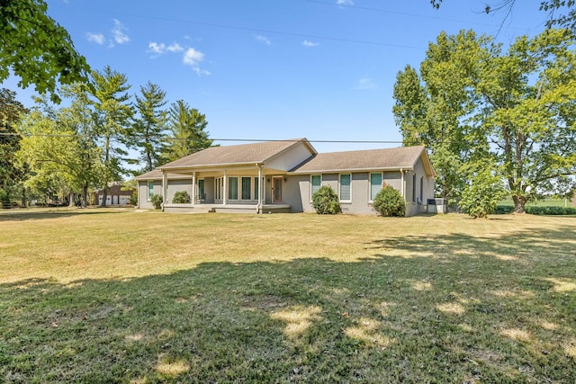 single story home featuring covered porch, central AC unit, and a front lawn