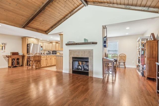 living room with beam ceiling, wooden ceiling, and light hardwood / wood-style flooring