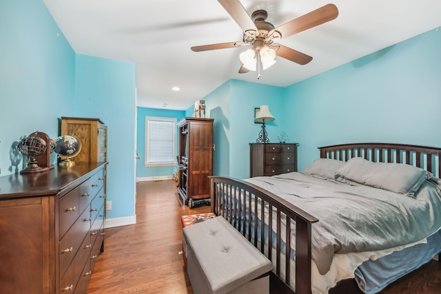 bedroom featuring dark hardwood / wood-style floors and ceiling fan