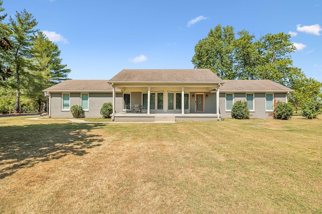 rear view of property featuring a porch and a yard