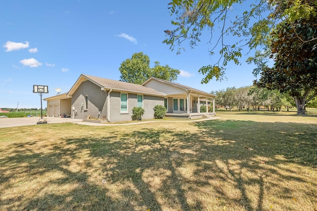 single story home with a front yard, a porch, and a garage