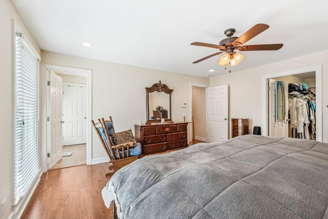 bedroom featuring multiple windows, a closet, a spacious closet, and ceiling fan