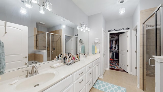 bathroom with tile patterned flooring, vanity, and an enclosed shower