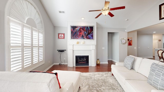 living room with dark wood-type flooring, ceiling fan, and lofted ceiling