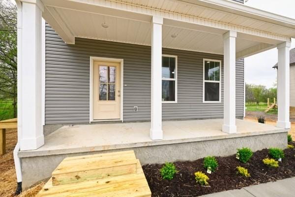 view of exterior entry with covered porch