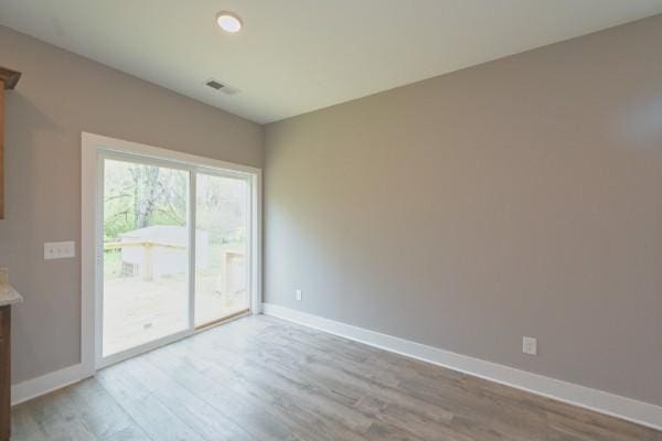 spare room featuring light wood-type flooring