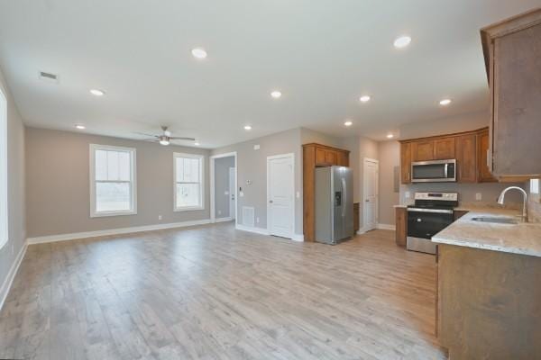 104A N St, Portland, TN 37148 - kitchen with appliances with stainless steel finishes, a sink, baseboards, light wood-style flooring, and recessed lighting