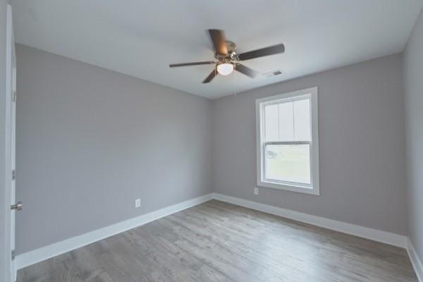 unfurnished room featuring ceiling fan and light wood-type flooring