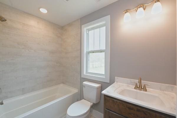 full bathroom with vanity, toilet, and tiled shower / bath