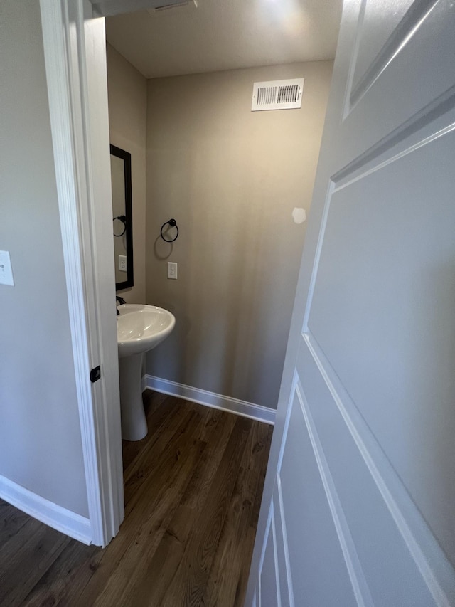 bathroom with wood-type flooring