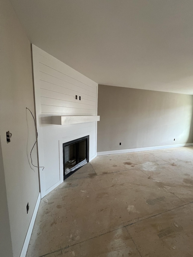 unfurnished living room featuring a large fireplace