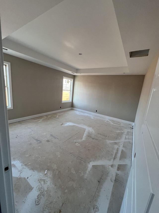 spare room featuring a tray ceiling