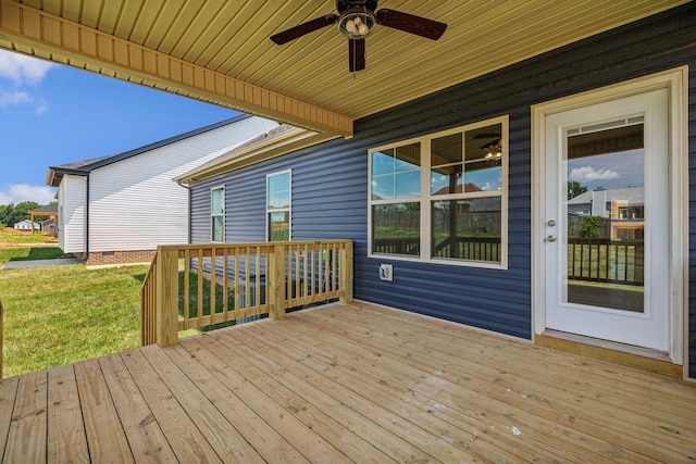 deck with a lawn and a ceiling fan