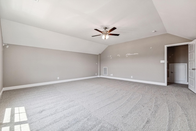 additional living space with vaulted ceiling, baseboards, visible vents, and carpet floors