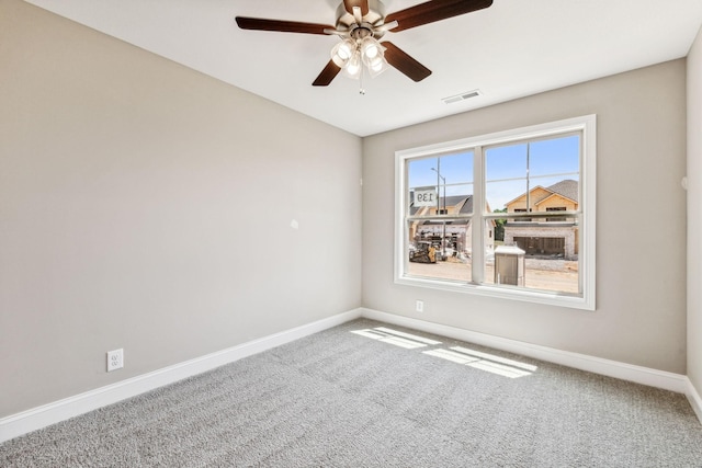 spare room featuring visible vents, ceiling fan, carpet, and baseboards