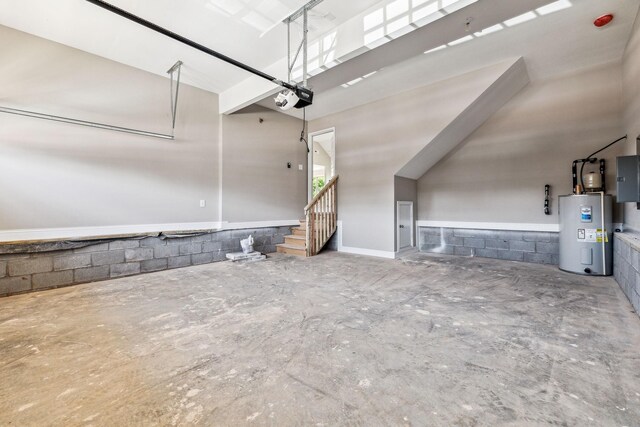 garage with electric panel, a garage door opener, and water heater