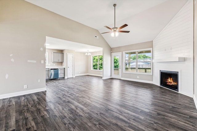 unfurnished living room with high vaulted ceiling, dark wood-type flooring, ceiling fan with notable chandelier, a fireplace, and baseboards