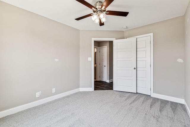 unfurnished bedroom featuring a closet, baseboards, carpet, and ceiling fan