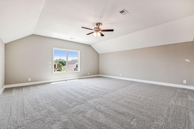 additional living space with visible vents, lofted ceiling, baseboards, and carpet flooring