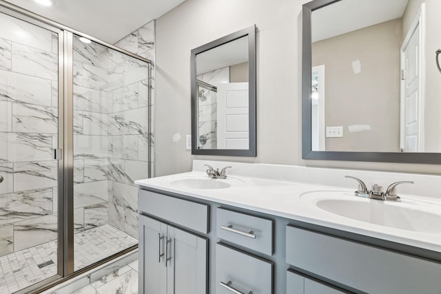 full bathroom featuring a marble finish shower, marble finish floor, double vanity, and a sink