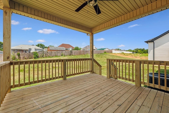 wooden deck featuring a lawn, a ceiling fan, a fenced backyard, cooling unit, and a residential view